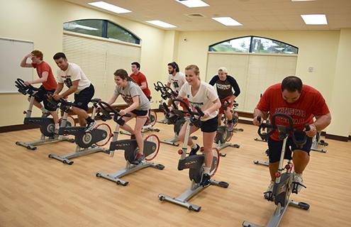 Students cycling on stationary bikes